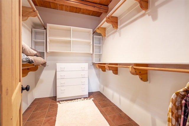 walk in closet with dark tile patterned floors