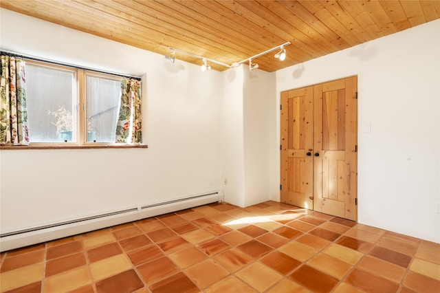 spare room featuring wooden ceiling, tile patterned flooring, rail lighting, and a baseboard radiator