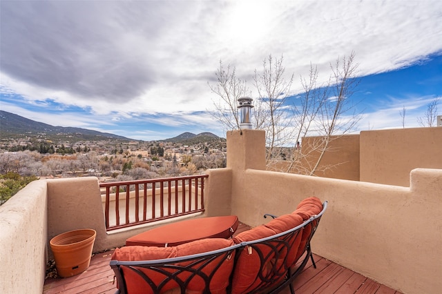 wooden deck with a mountain view