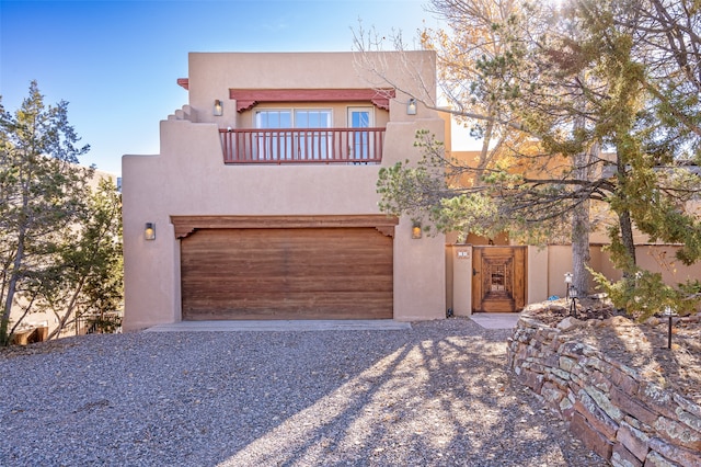 adobe home with a balcony and a garage