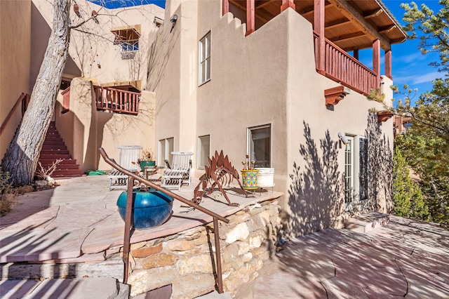 view of patio featuring a balcony