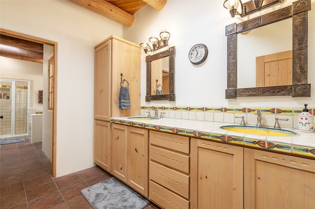 bathroom with beamed ceiling, vanity, tile patterned flooring, and a shower with door