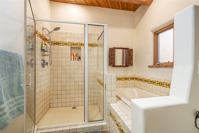 bathroom featuring independent shower and bath