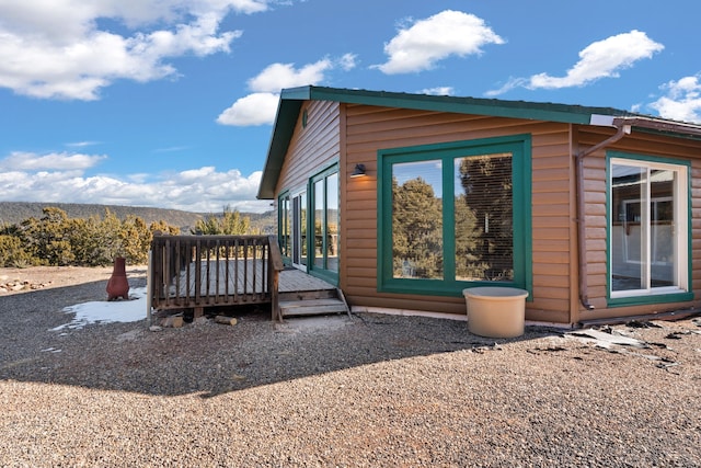 view of home's exterior featuring a wooden deck