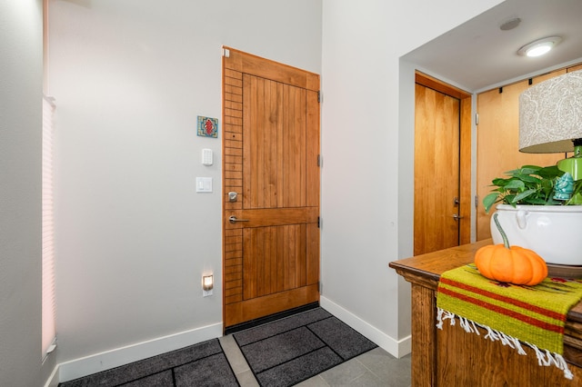 foyer entrance with light tile patterned flooring