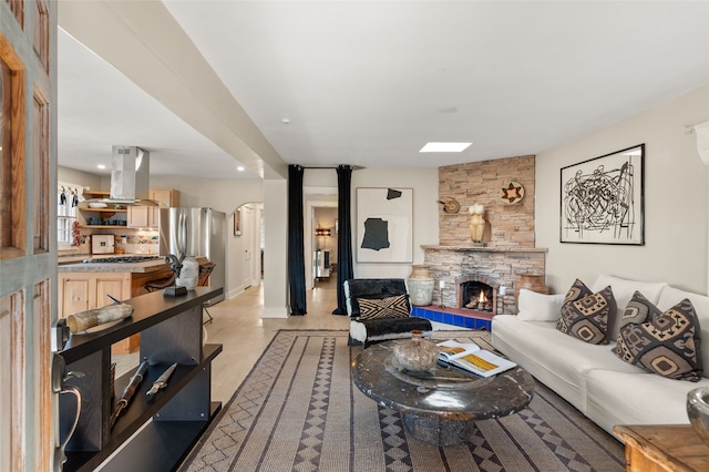 living room featuring a stone fireplace