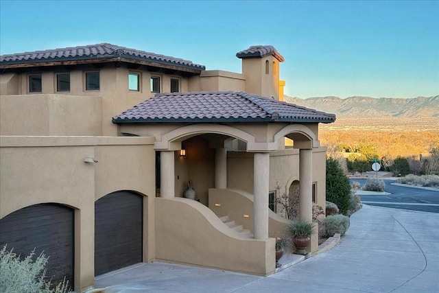 view of front facade featuring a mountain view and a garage