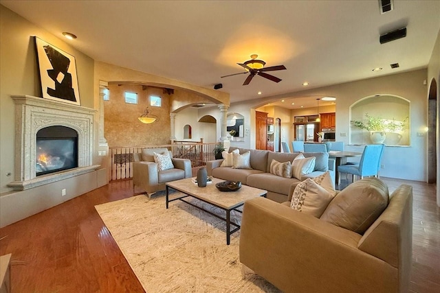 living room with ceiling fan and hardwood / wood-style flooring