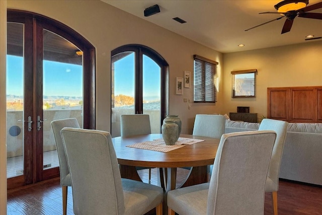 dining space with dark hardwood / wood-style floors and ceiling fan