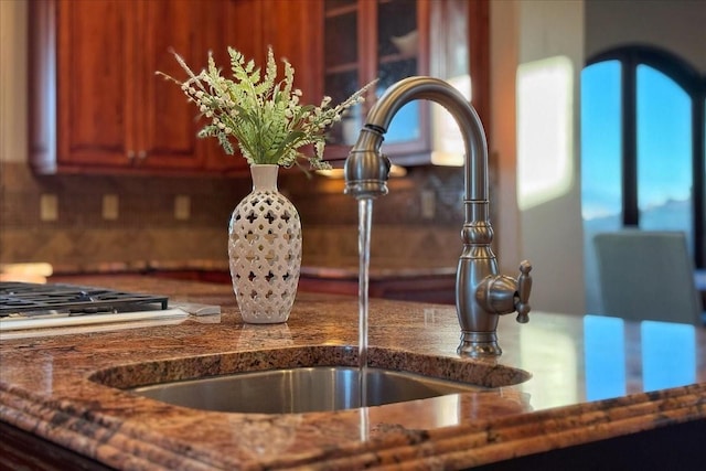 details featuring tasteful backsplash and sink