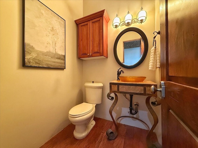 bathroom featuring sink, hardwood / wood-style floors, and toilet