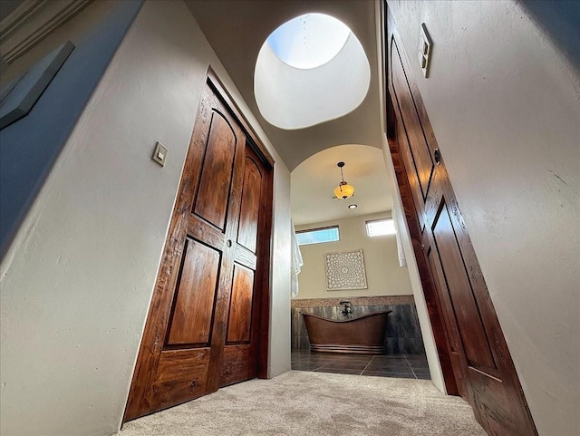 hallway featuring light colored carpet