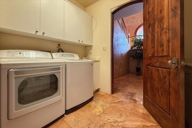 washroom with cabinets and separate washer and dryer