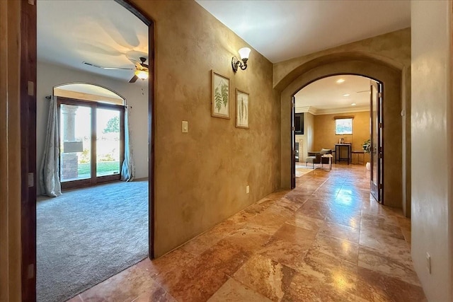 hall with crown molding and carpet