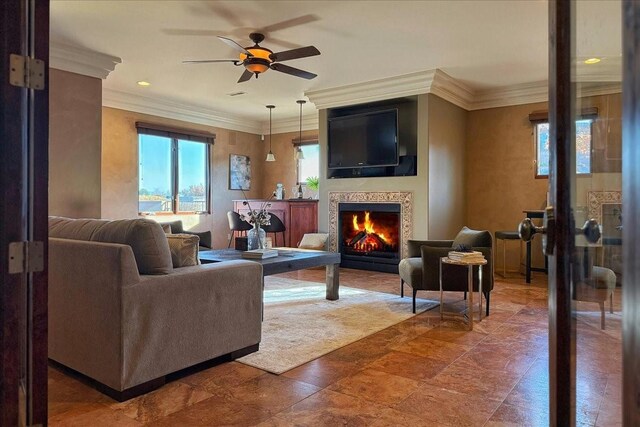 living room with ceiling fan and crown molding