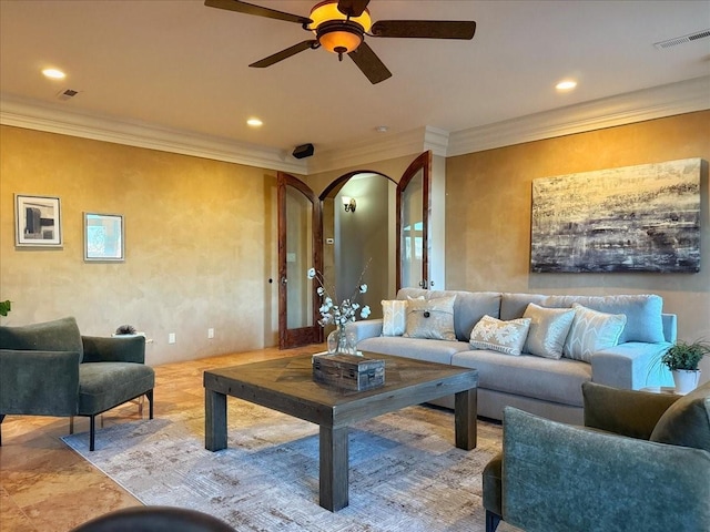 interior space with ceiling fan and ornamental molding