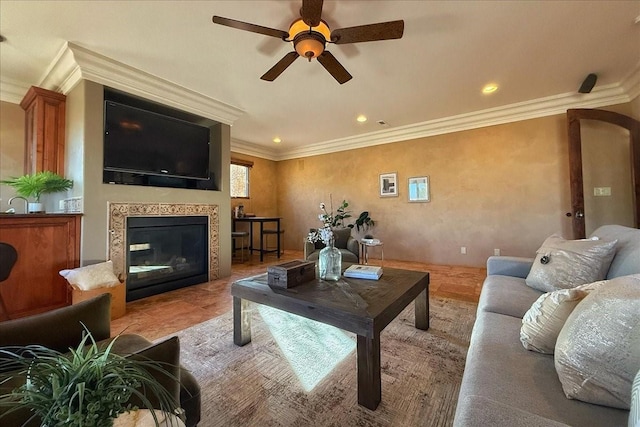 living room with ceiling fan, ornamental molding, and a premium fireplace