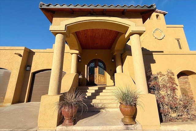 view of exterior entry featuring french doors