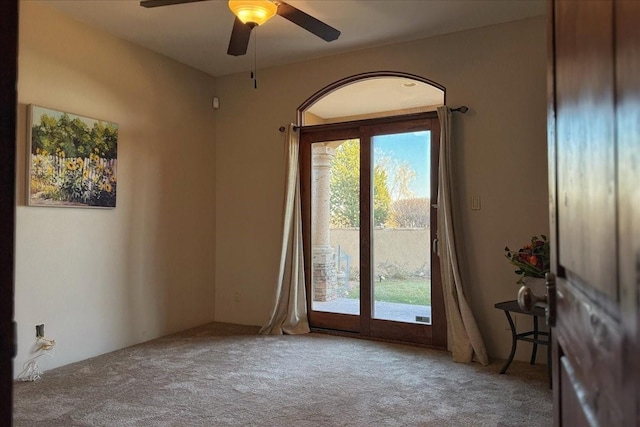 carpeted empty room with ceiling fan and a healthy amount of sunlight