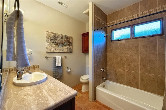 full bathroom with tile patterned flooring, vanity, toilet, and tiled shower / bath