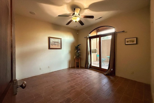 spare room featuring ceiling fan and dark hardwood / wood-style floors