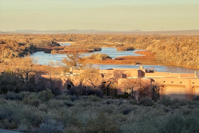 exterior space with a water and mountain view