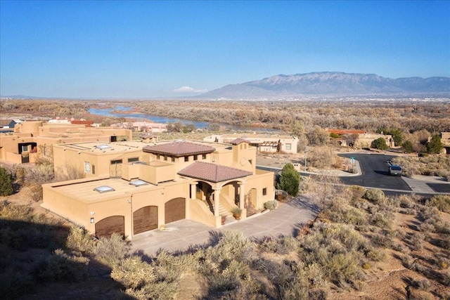 birds eye view of property with a mountain view