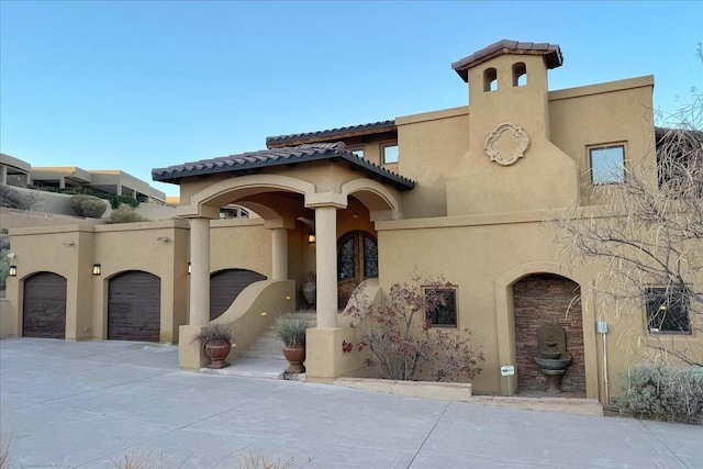 mediterranean / spanish house featuring a garage