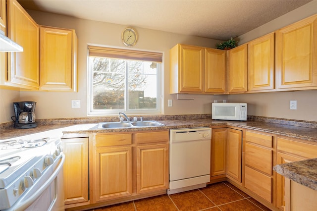 kitchen featuring a textured ceiling, white appliances, exhaust hood, sink, and dark tile patterned flooring