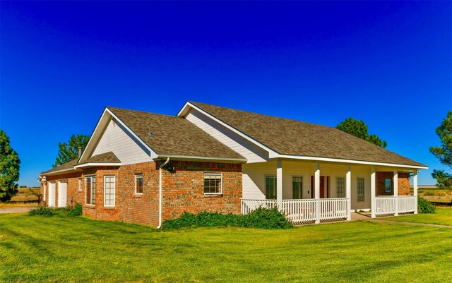 ranch-style home with a porch and a garage