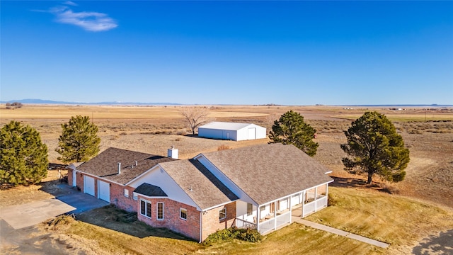 birds eye view of property featuring view of desert and a rural view