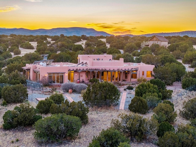 aerial view at dusk featuring a mountain view