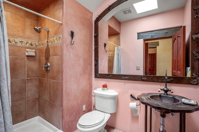 bathroom with toilet and walk in shower