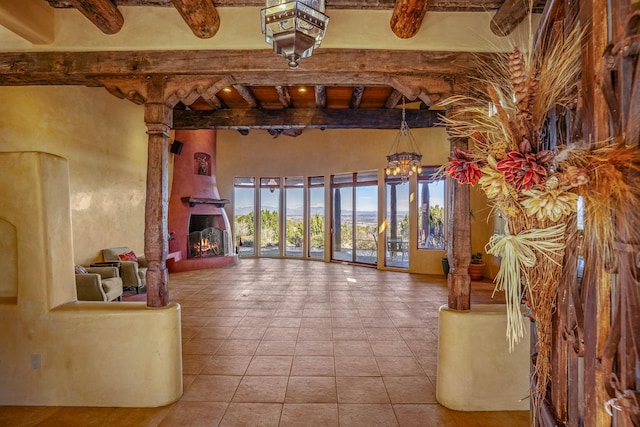 living room featuring beam ceiling and a chandelier