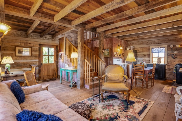 living room with beamed ceiling, hardwood / wood-style floors, wooden ceiling, and wood walls