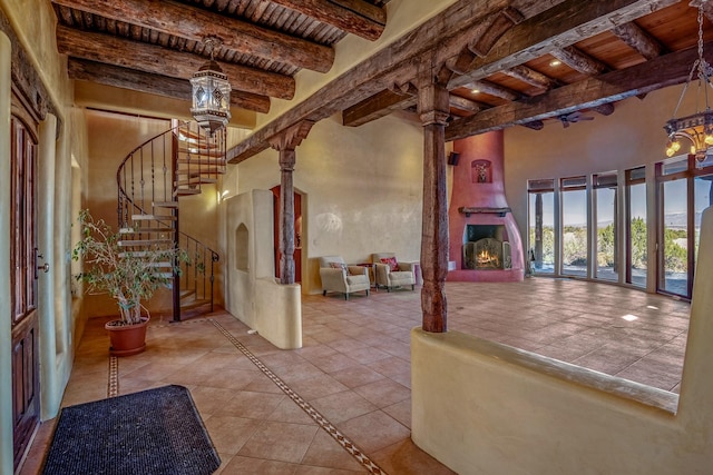 foyer entrance with light tile patterned flooring, french doors, beamed ceiling, and wooden ceiling