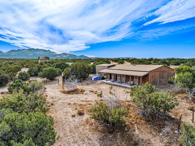 back of house with a mountain view and an outbuilding