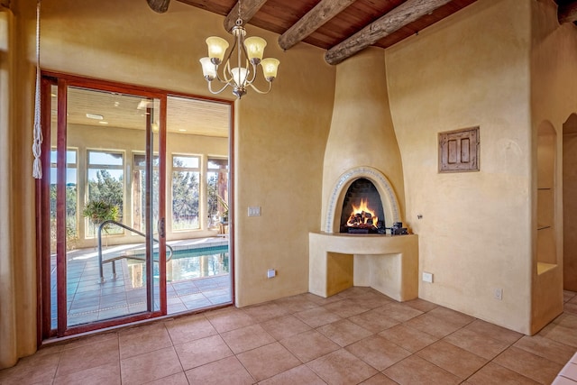 interior space featuring wooden ceiling, tile patterned flooring, a fireplace, beam ceiling, and a chandelier