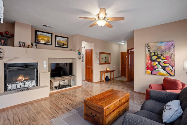 living room with wood-type flooring and ceiling fan