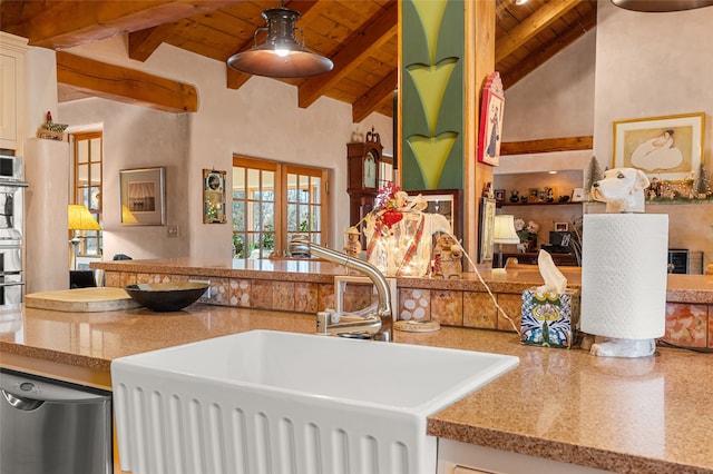 kitchen with beam ceiling, dishwasher, white cabinets, wood ceiling, and sink