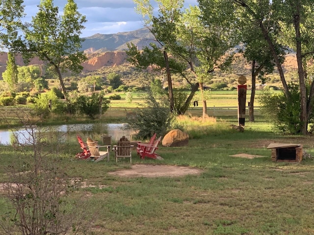 view of yard featuring a water and mountain view