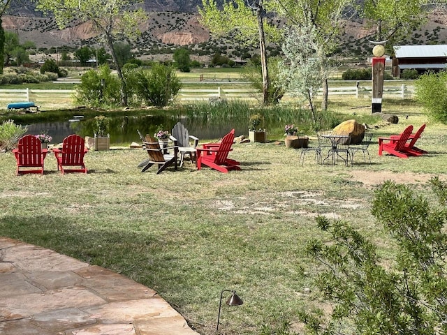 view of home's community with a yard and a water view