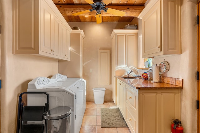 clothes washing area featuring ceiling fan, wood ceiling, sink, washer and dryer, and cabinets