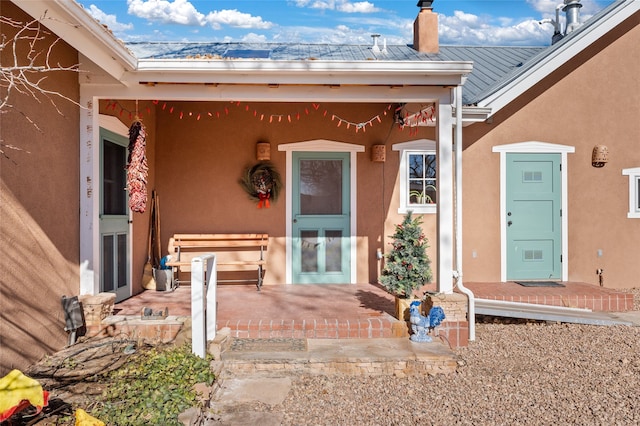 property entrance featuring a patio area