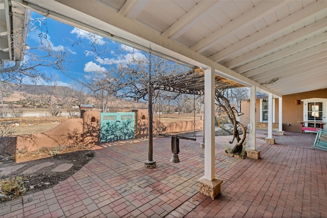 view of patio / terrace with a pergola and a mountain view