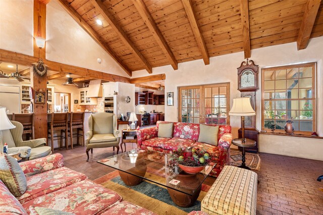 living room with ceiling fan, beamed ceiling, wood ceiling, and high vaulted ceiling