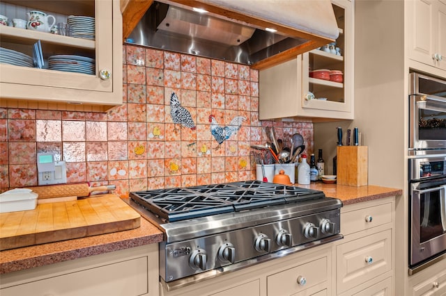 kitchen with stainless steel appliances, wall chimney exhaust hood, and backsplash