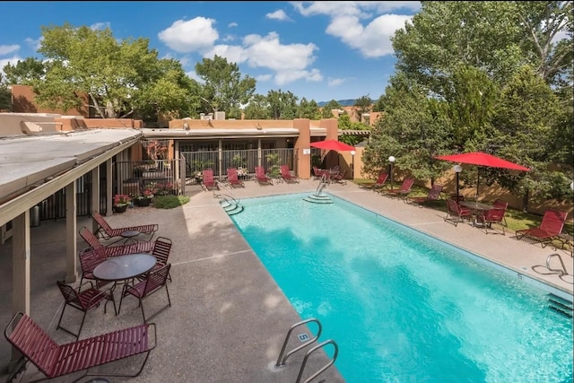 view of swimming pool featuring a patio area