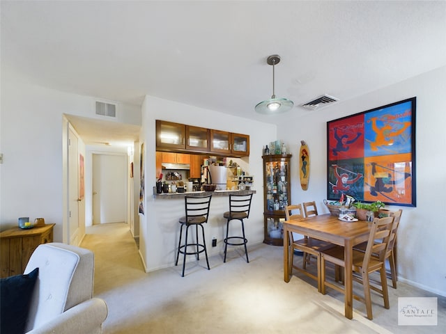 dining area featuring light carpet