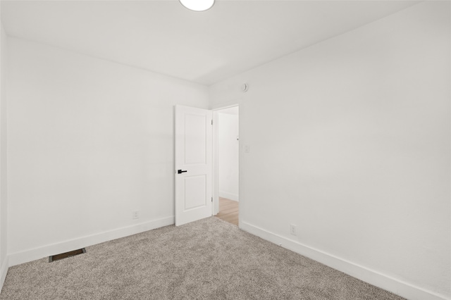 spare room featuring light colored carpet